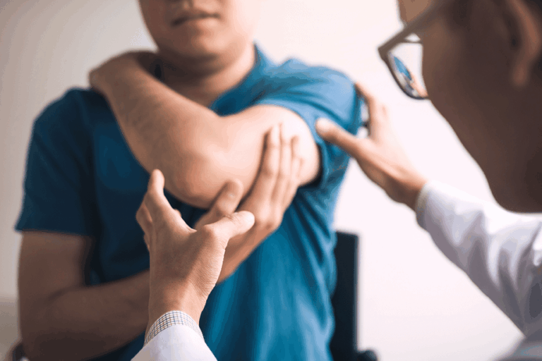 Image of a doctor examining under a patients arm.